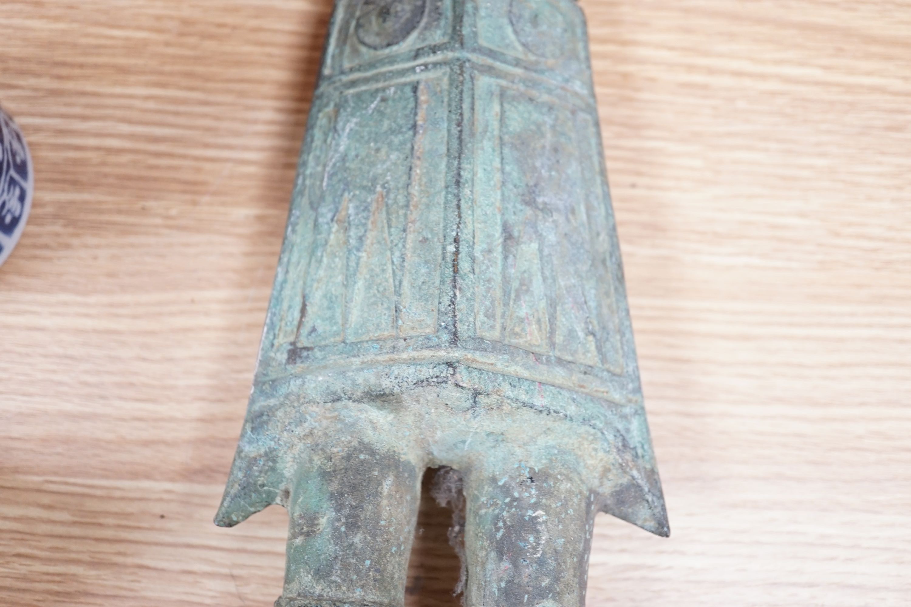 A large, archaic tic bronze figure, 76cm, and a bronze bell on chain